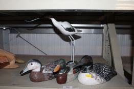 A wooden ornament in the form of an avocet togethe