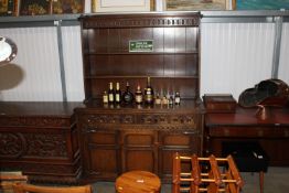 An Old Charm style oak dresser raised on cupboard