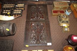 A pair of Continental carved plaques decorated with griffins