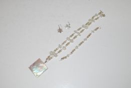A mother of pearl pendant, necklace with matching