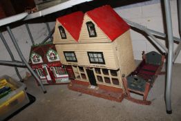 A vintage dolls house in the form of a village pos