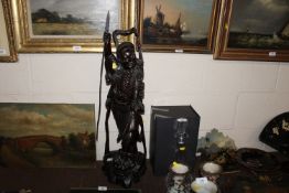 An unusual Chinese carved hardwood figure of a man