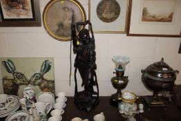 An unusual Chinese carved hardwood figure of a man