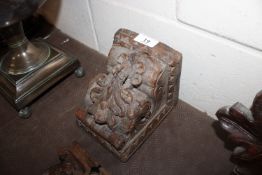 An antique carved oak corbel