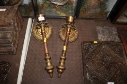 A pair of metal and gilded wall mounting candle ho