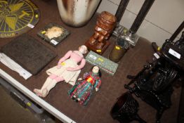 A carved Hawaiian figure; two antique dolls; a Chinese POW Trench Art item and two cased enamel