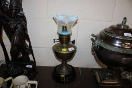 A brass oil lamp with Vaseline glass shade, converted to electricity