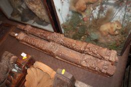 A pair of antique carved columns with naïve style