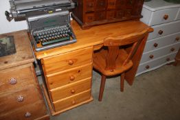 A pine single pedestal desk fitted four drawers to