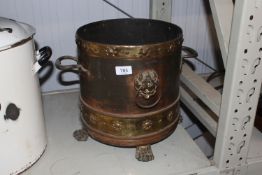A copper and brass twin handled bucket having lion