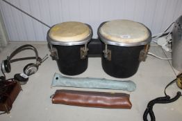 A pair of bongos together with a Yamaha recorder a