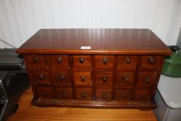 A table top bank of wooden drawers