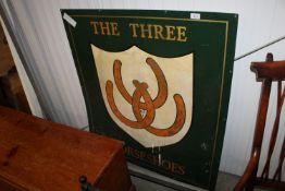 A tin pub sign for 'The Three Horseshoes'