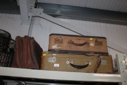 A leather bag together with two suitcases