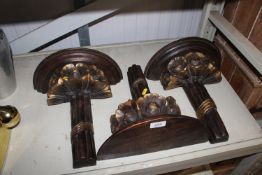 Three wooden and gilt decorated wall shelves