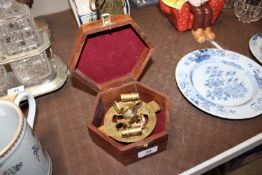 A reproduction brass sextant in hexagonal case
