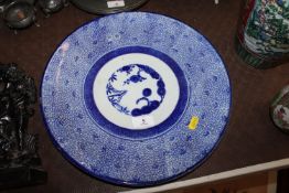 An Oriental blue and white decorated shallow dish 35.5cm diameter
