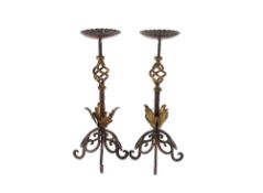 A pair of wrought iron pricket candle sticks with