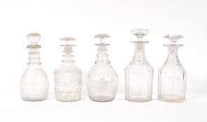 A near pair of 19th Century ring necked decanters, the largest 27 cm high; a near pair of triple