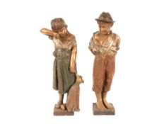 A pair of large continental pottery figures of young boy and girl, 57cm high