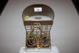 A mirrored display stand and contents of costume j