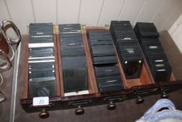 Five wooden drawers containing various magic lante