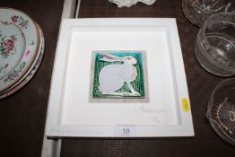 A Framed Figment ceramics painted tile, decorated