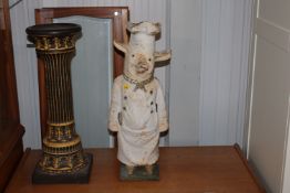 A cast iron door stop in the form of a butcher pig
