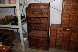 A hardwood storage unit fitted with integral wine
