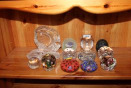 A quantity of various glass paper weights to inclu