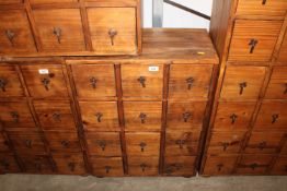 A hardwood storage unit fitted 12 drawers