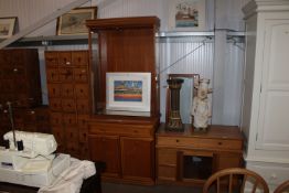 A modern display cabinet, raised on cupboard base,