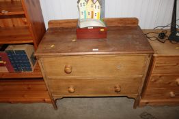 A pine chest fitted two drawers lacking one handle