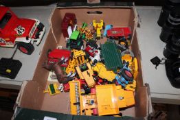A box containing various Britains Die-cast tractors and various other farmyard accessories