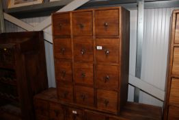 A hardwood storage unit fitted 12 drawers