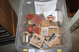 A box containing approximately 50 craft stamps