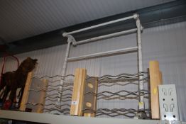 A painted towel rail and two wine racks
