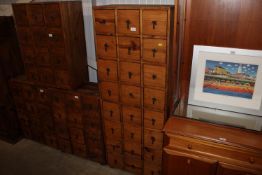 A hardwood storage unit fitted 24 drawers