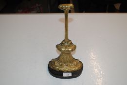 An antique brass and iron doorstop