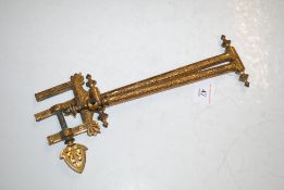 An antique ornate swivel arm wall bracket