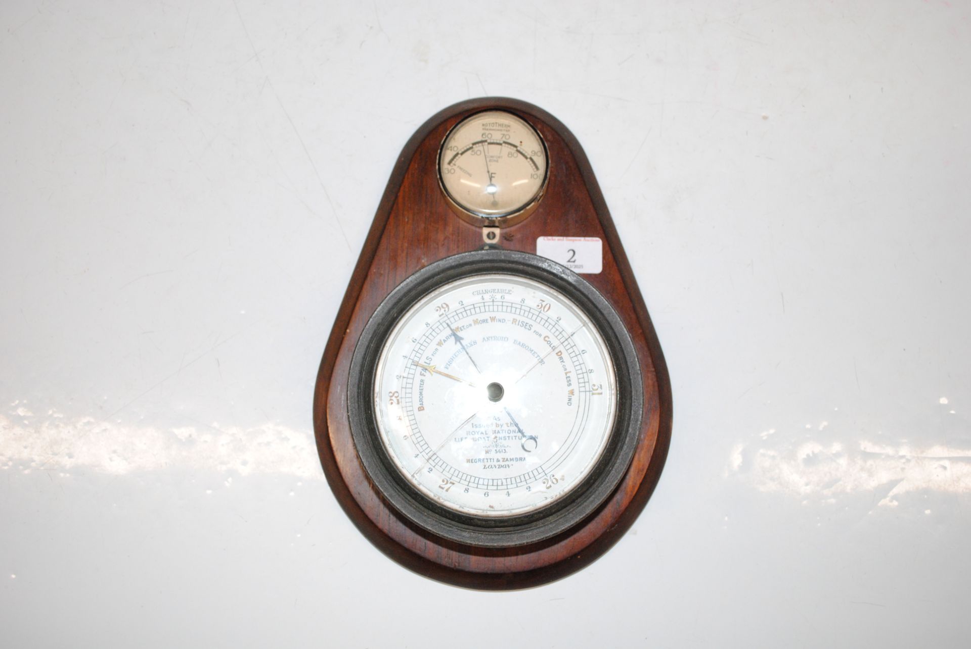 A Negretti & Zambra fisherman's aneroid barometer mounted to a plaque ...