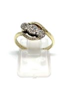 Diamond three stone cross over ring stamped 9CT, overall weight 2.