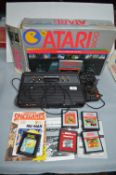 Atari 2600 Video Computer System with Pac-Man and Other Game Cartridges