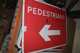 *Five Pedestrians Left Signs for Cones