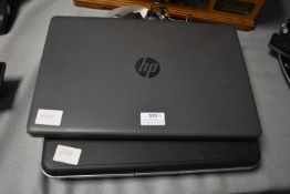 One Compaq and One HP Laptops