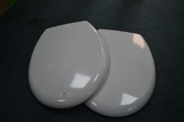 *Two White Toilet Seats