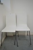 *Two Stackable White Chairs on Tubular Frames