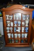 Collectors Cabinet Containing Decorative Egg Cups