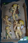 Four Decorative Cherubs playing Instruments