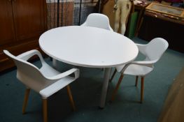 Circular Table and Three White Chairs